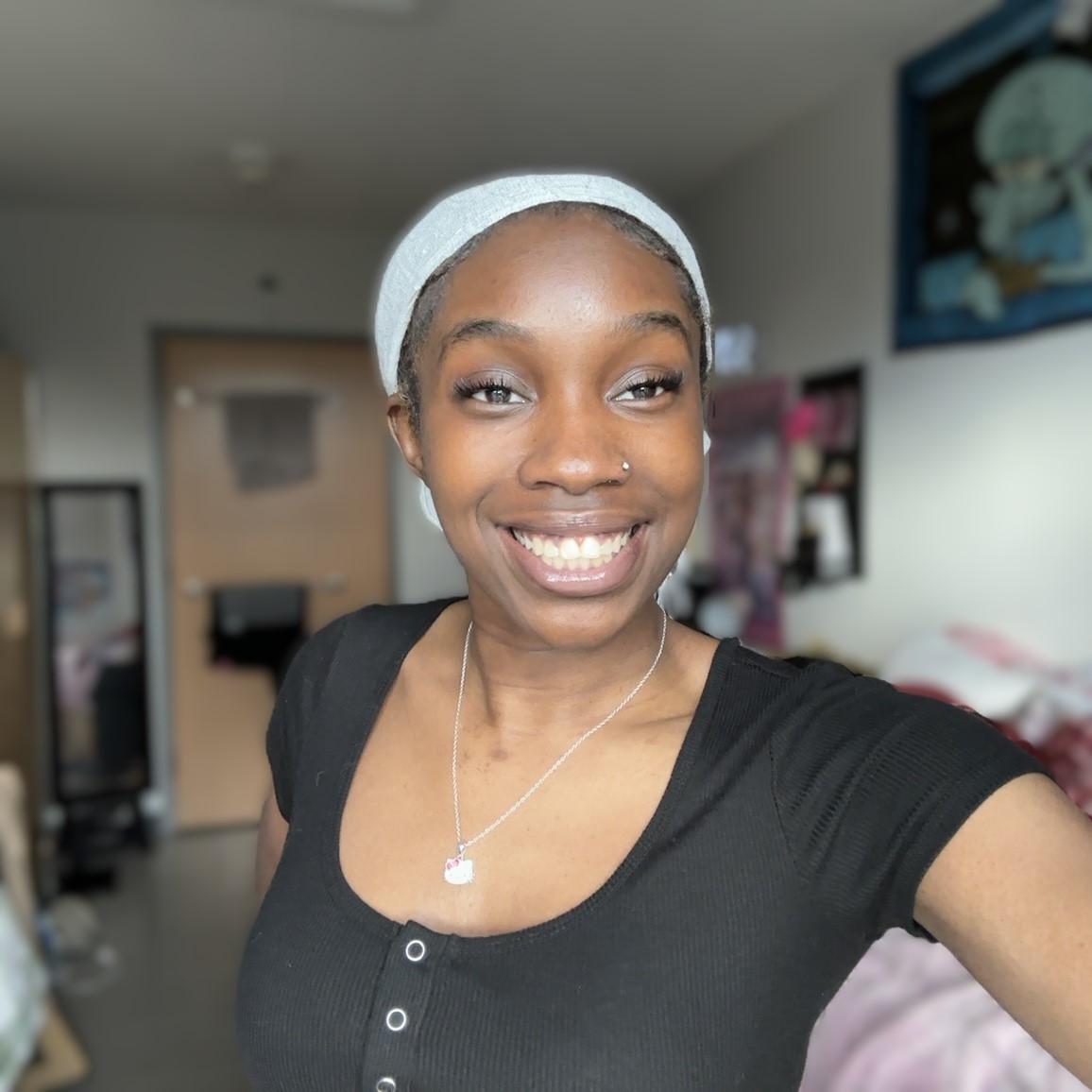 Picture of Temi smiling in black top